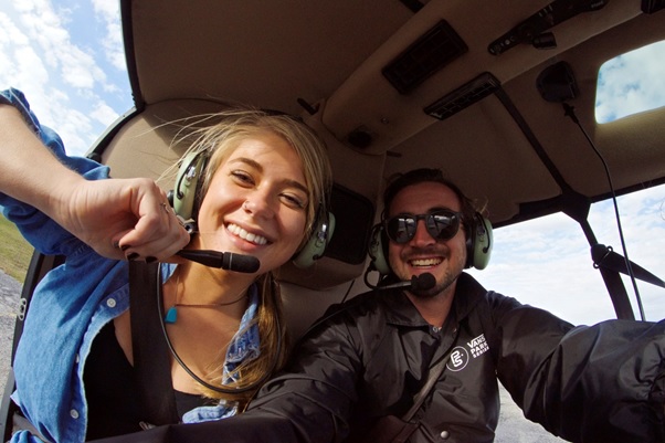 A couple taking a selfie during an aerial tour in Florida.