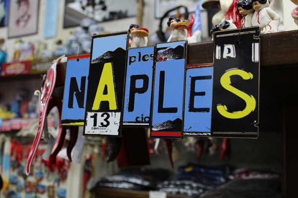 A wall decoration that spells out “Naples” from license plate cutouts.