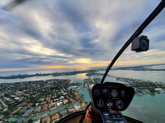 The perspective from the passenger seat during an aerial helicopter tour in Florida.