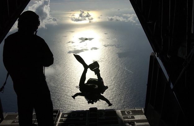 A skydiver taking off from a helicopter