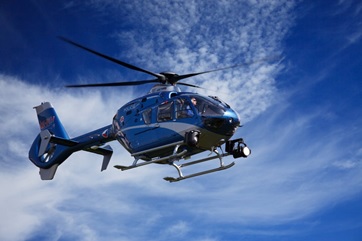 A blue helicopter in the sky