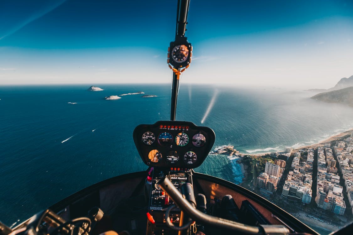 An aerial view of a city through a helicopter