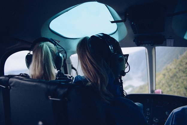 Two girls sitting in a helicopter and enjoying the view